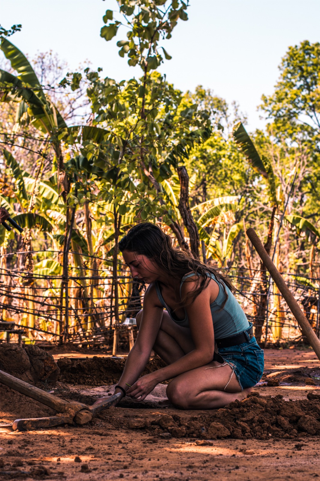 Jazmin Walsh, a Gen Z volunteer from the UK, working at Bagdara Farms with tools and hands-on farming activities.