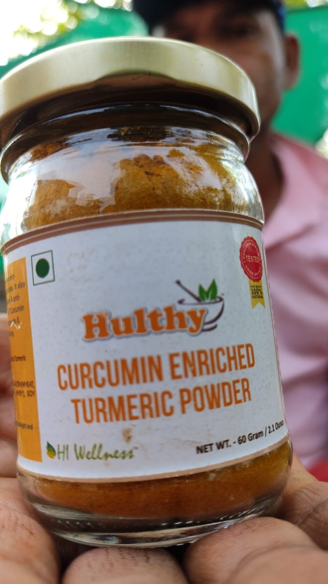 Bottle of Bagdara Turmeric held in a farmer's palm, promoting turmeric benefits for women.